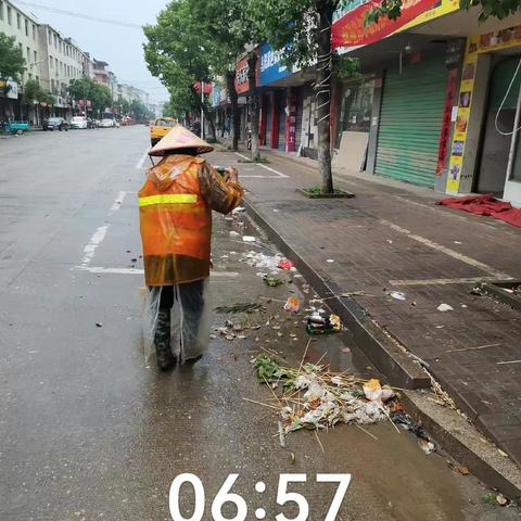 为确保路面卫生达标，保洁员雨中保洁！