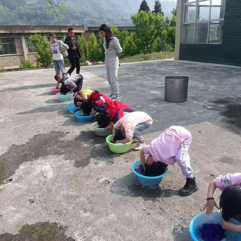 化作乡以麦小学组织低年级同学洗头活动，培养低年级学生自主能力及养成良好的卫生习惯。