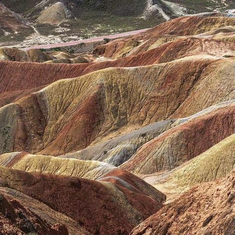 如大地喷炽焰烈火，似群山披五彩霓裳